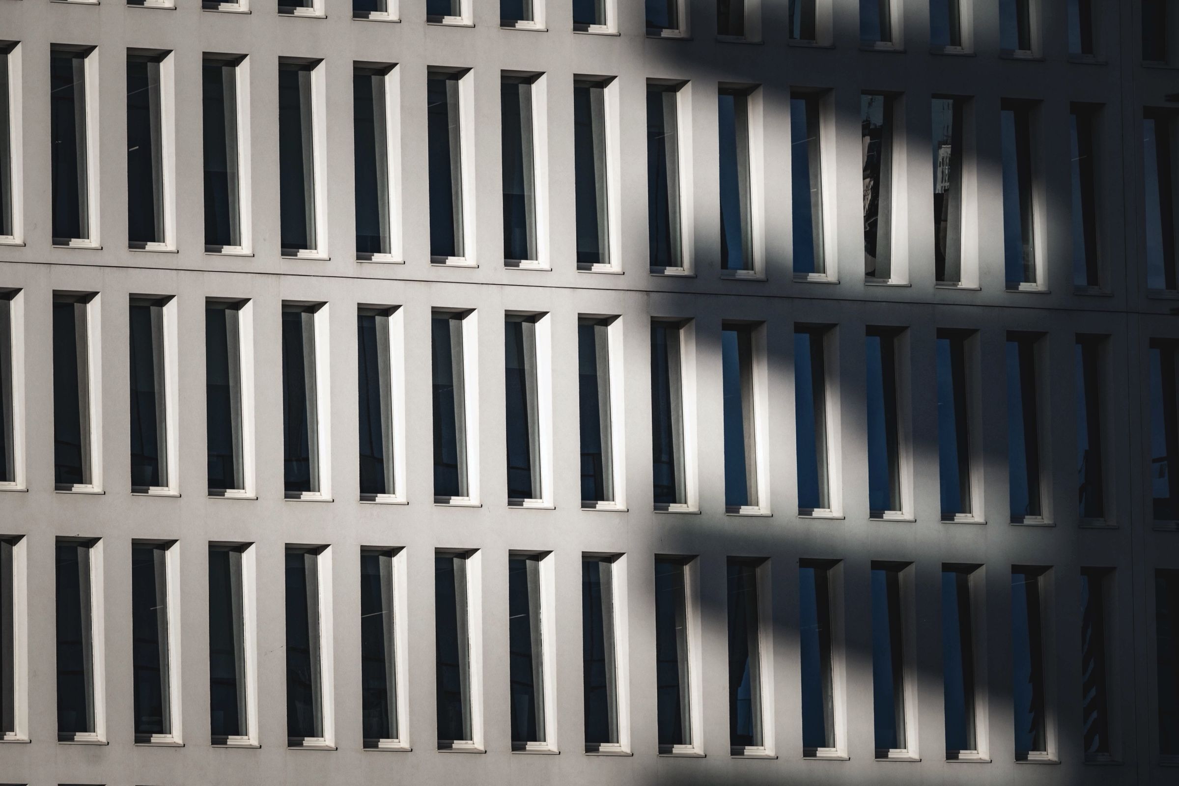 Shadows of a concrete sunscreen on a facade.
