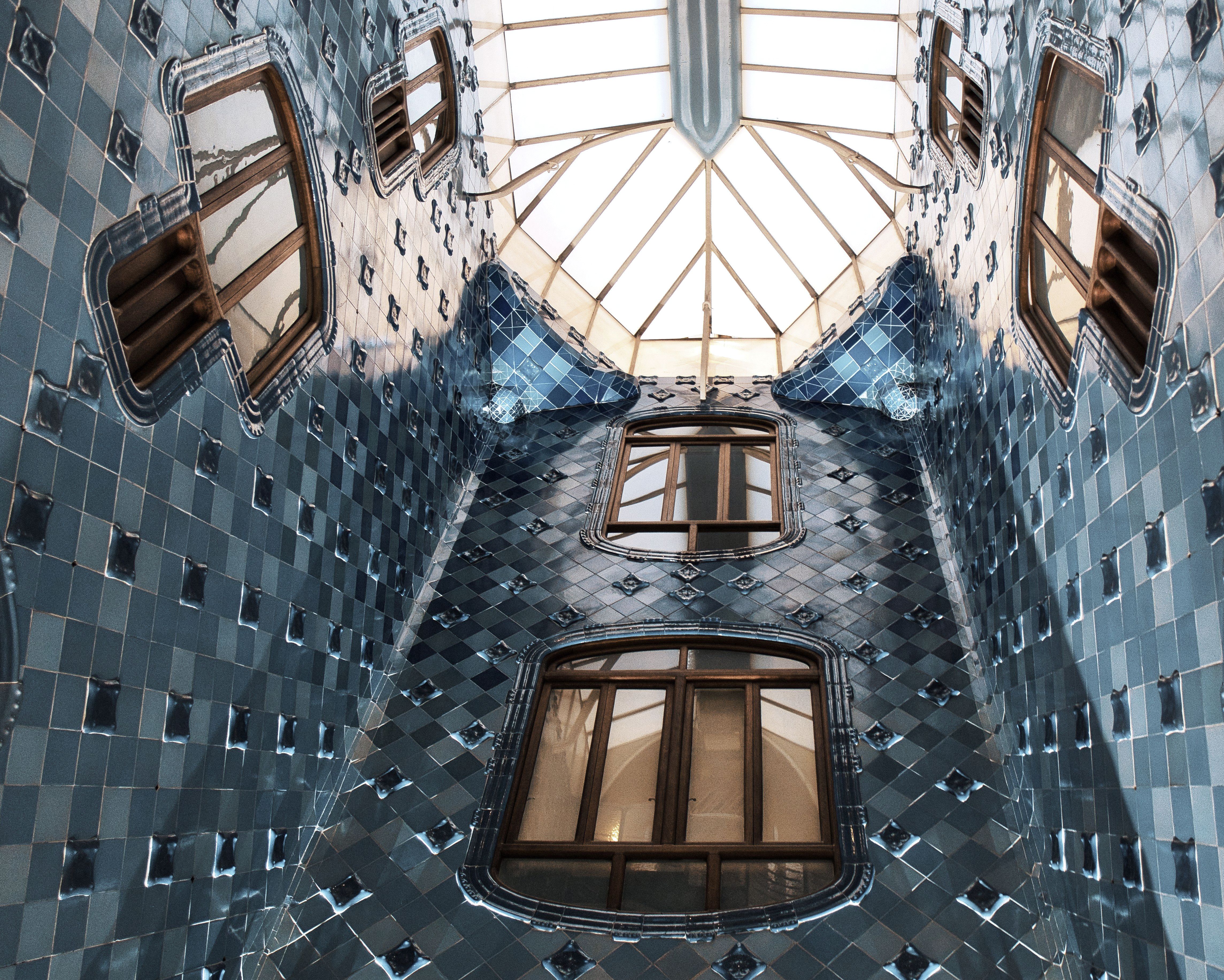 The blue-tiled light well of Casa Batllo in Barcelona, seen up to the skylight.