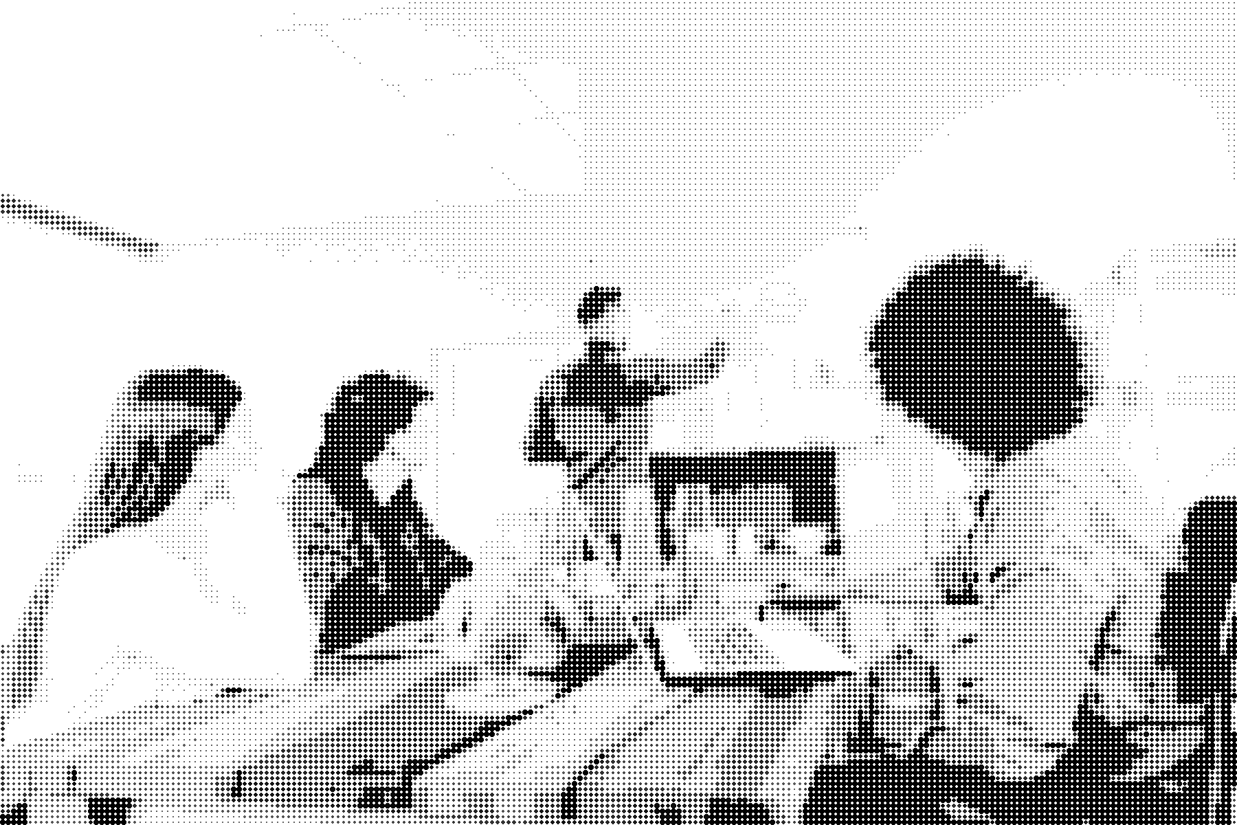 Four people working together at a table, drawn as a dot screen